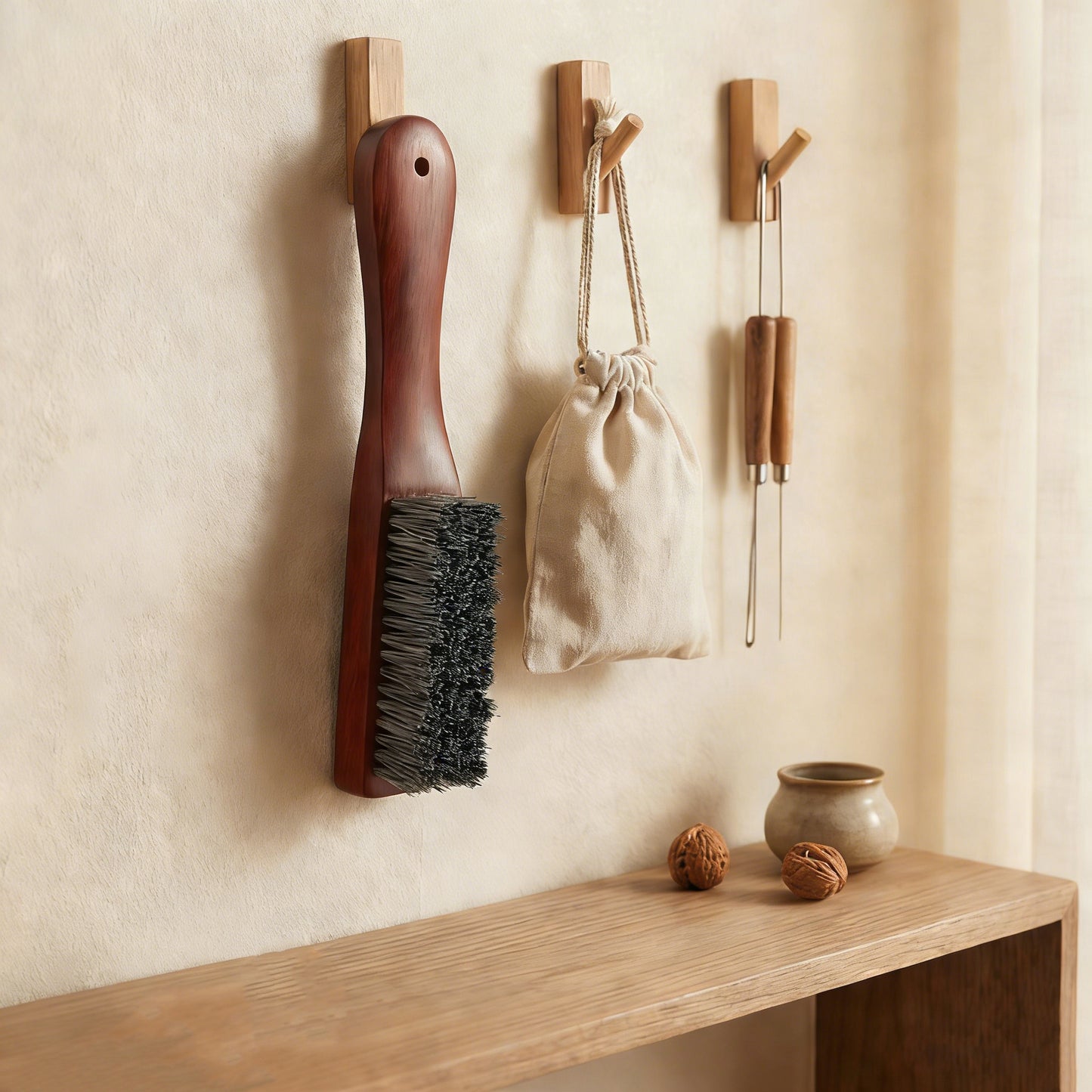 The PatinaProject professional sandalwood restoration brush with wooden handle and bristles for caring and restoring wood surfaces.