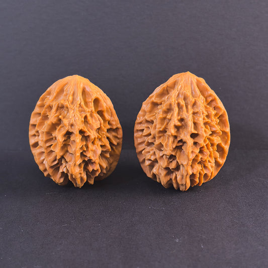 Walnut hand exercisers featuring the Fortune Mouse (Zhao Cai Shu) design, 40mm prosperity pair by ThePatinaProject.