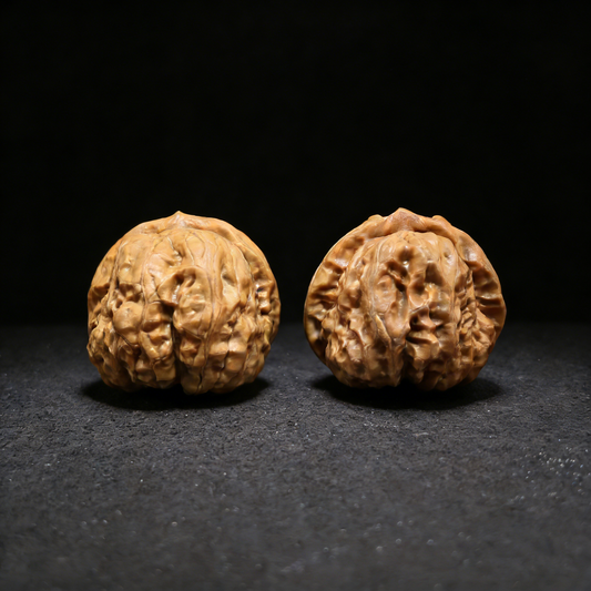 Walnut hand exerciser pair called Golden Toad (Ha Ma Tou) by ThePatinaProject, 39mm wealth guardian shown in the image.