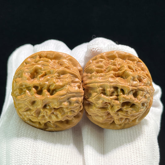 Pair of ThePatinaProject Harmony Walnut Hand Exercisers with 40mm diameter, showing smooth wooden finish and ergonomic design.