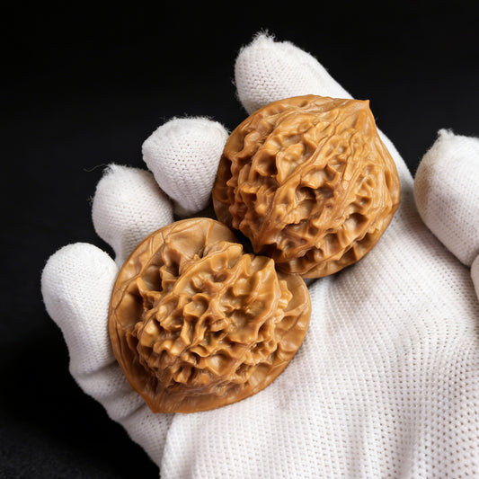 Pair of Walnut Hand Exercisers called Lantern (Deng Long) by ThePatinaProject, measuring 39mm x 37mm, with textured surfaces.