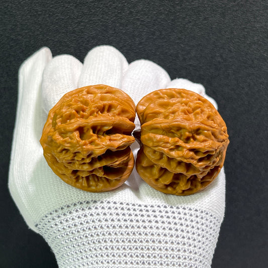 Pair of Peach Heart Xia Yun Ling walnut hand exercisers by ThePatinaProject, 40mm x 36mm, featuring intricate carved heart designs.