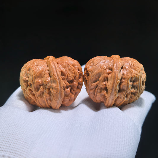 Pair of Walnut Hand Exercisers shaped like Yuan Bao ingots, 40mm x 42mm, from ThePatinaProject's Pinggu collection.