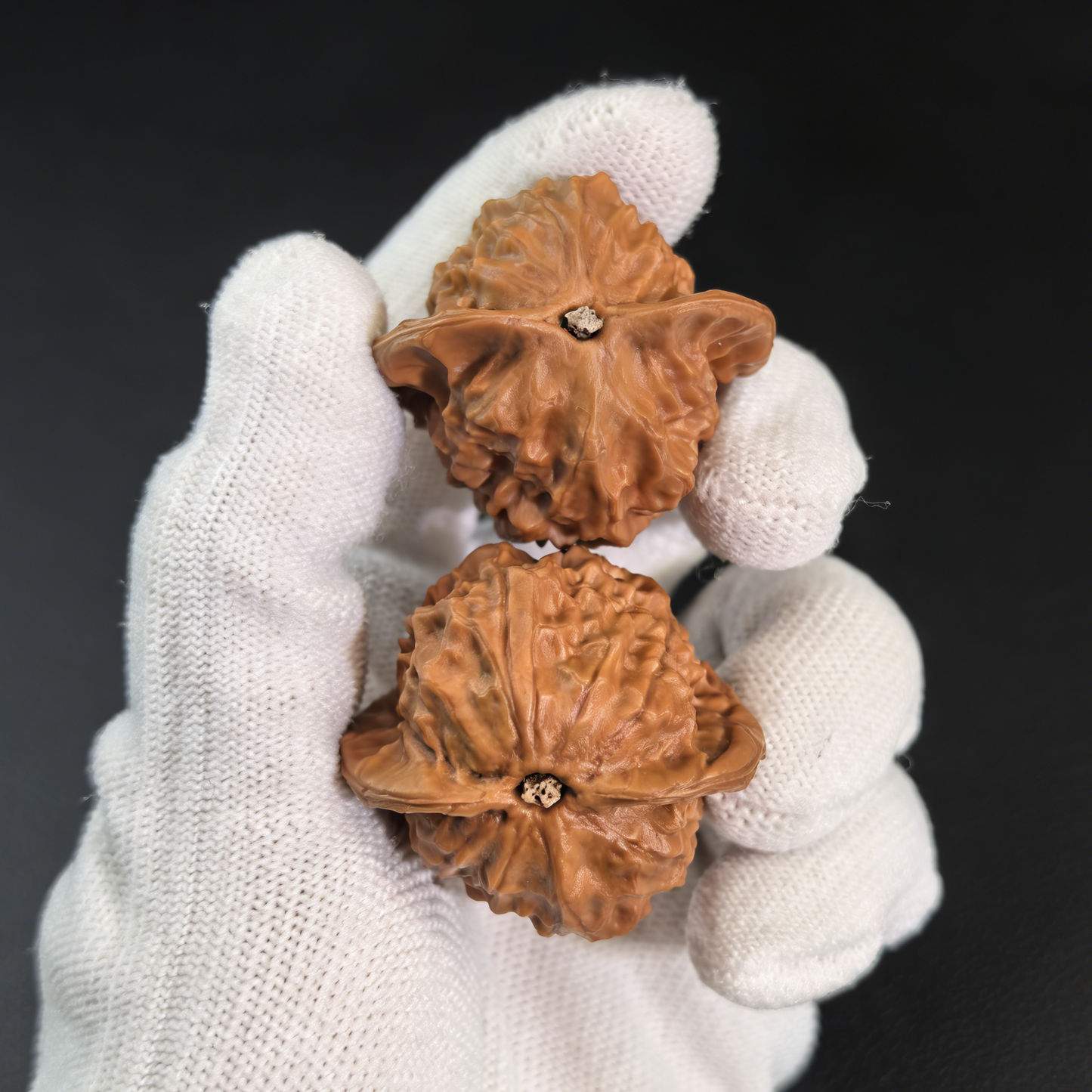 Walnut hand exerciser with porcelain doll design, waxy luster finish, 38mm diameter, by ThePatinaProject, part of collector’s pair