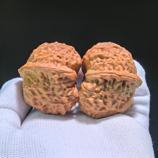 Walnut hand exercisers called Pumpkin Squat (Nan Gua Dun) pair, 41mm x 44mm, from ThePatinaProject, shown in the image.