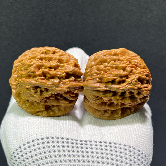 Pair of walnut hand exercisers with lion's head design, balanced 40mm size, boutique grade by ThePatinaProject.