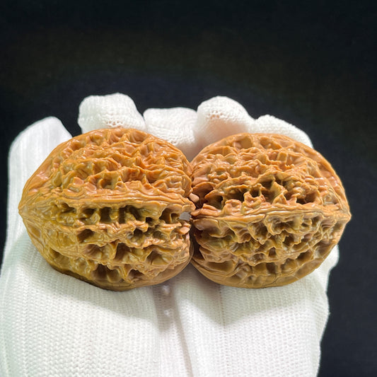 Pair of Wild Ox Walnut Hand Exercisers by ThePatinaProject, 43mm x 42mm, showing smooth wooden handles and ergonomic design.