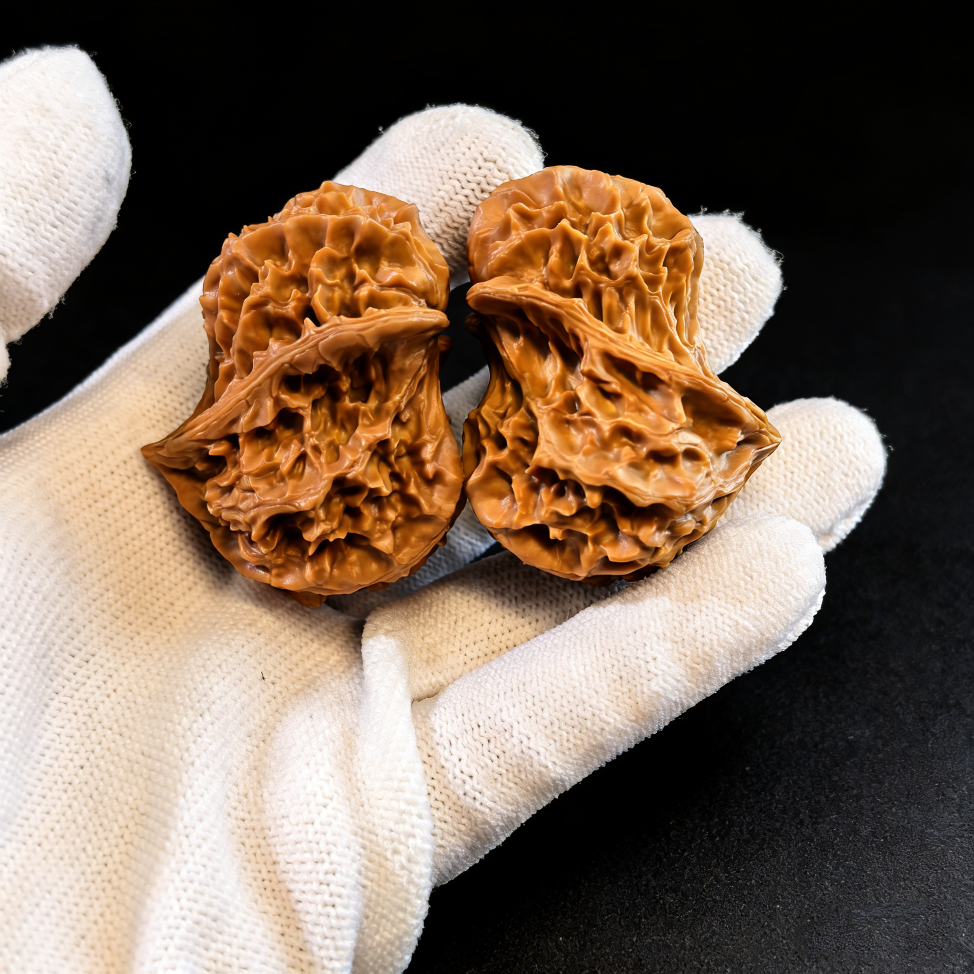 Pair of natural walnut Alien Bird hand exercisers from The Patina Project, featuring ergonomic, asymmetrical design for fidgeting and hand strength.