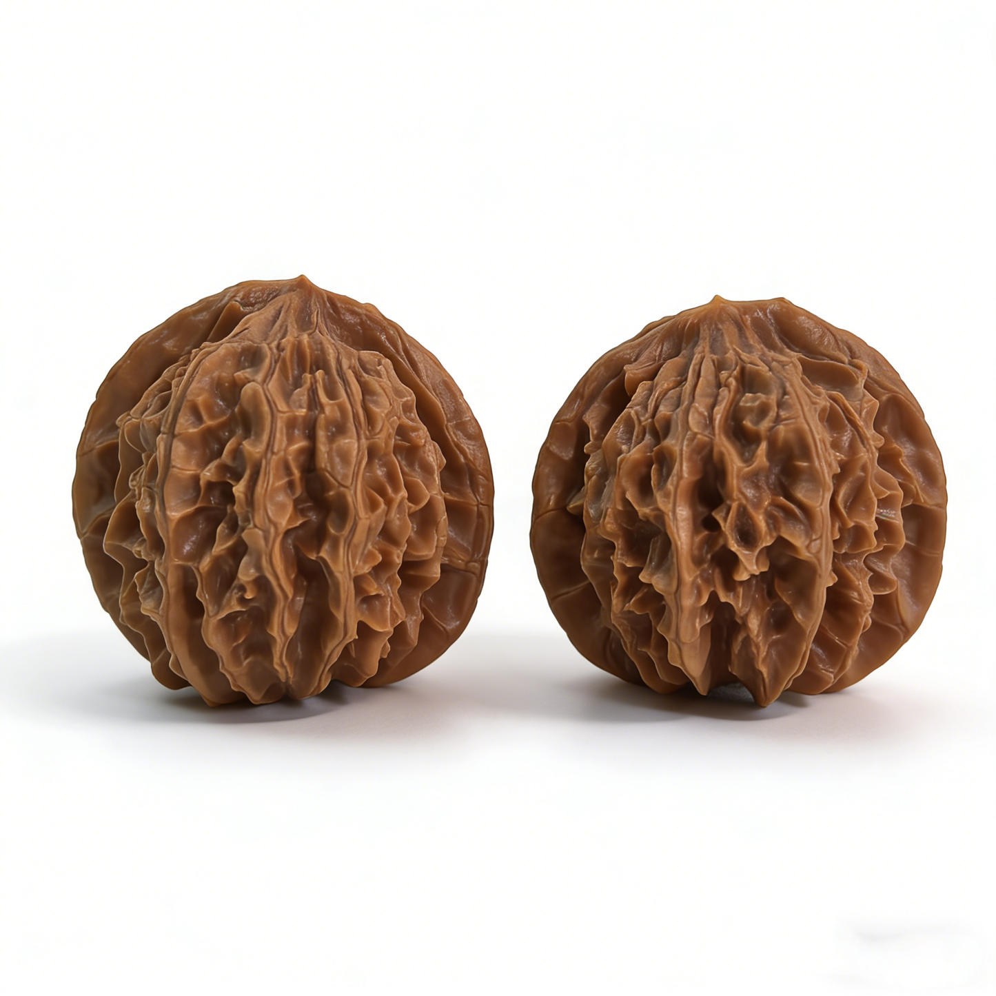 Pair of Walnut hand exercisers called Lantern by The Patina Project, featuring deep volcanic ridges and classic sphere design.
