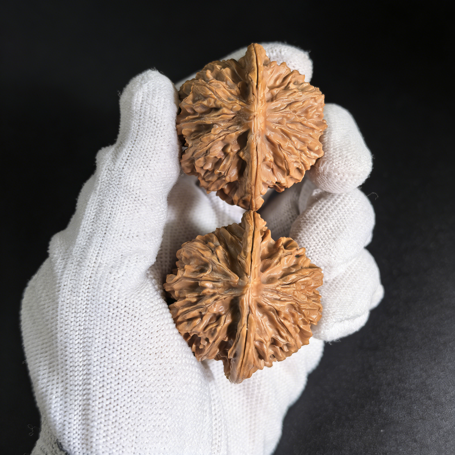 Pair of walnut hand exercisers with deep volcanic ridges and classic sphere design, 43mm size from The Patina Project.