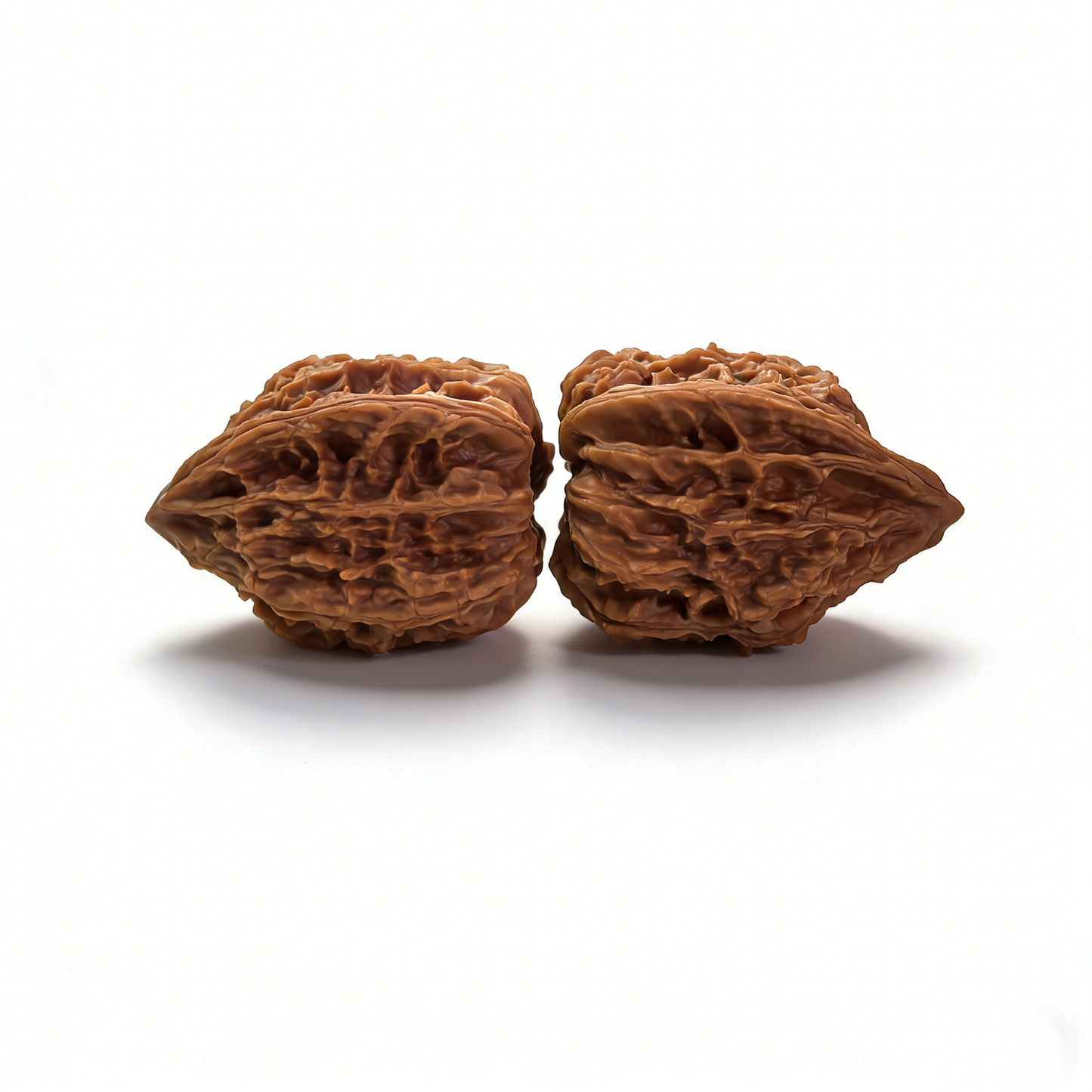 Pair of walnut hand exercisers with celestial "Stardust" texture, designed for finger and hand strength training.
