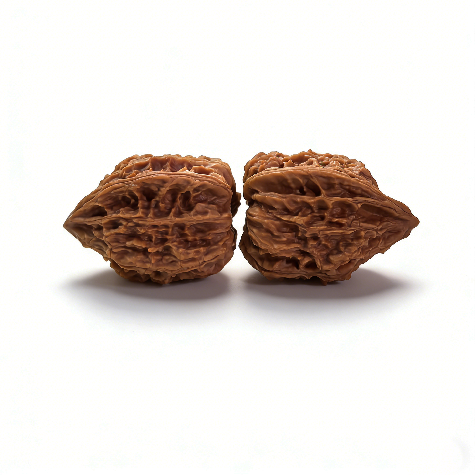 Pair of walnut hand exercisers with celestial "Stardust" texture, designed for finger and hand strength training.