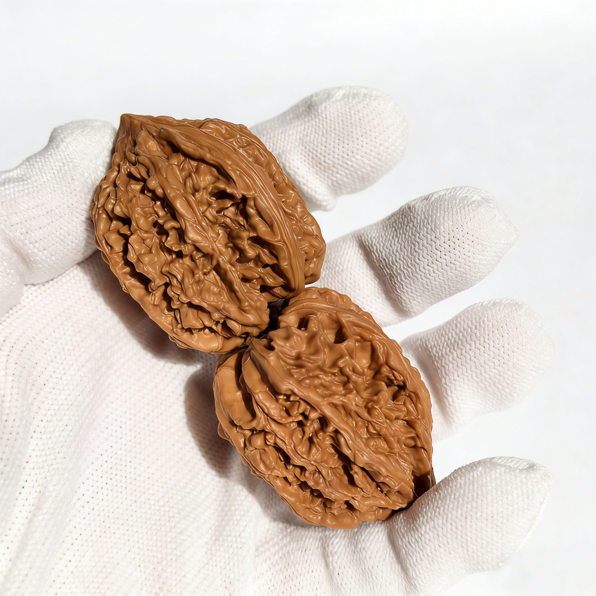 Pair of walnut hand exercisers with high-relief "Nine Dragon Sinews" dragon bone texture, 35mm size, by The Patina Project.