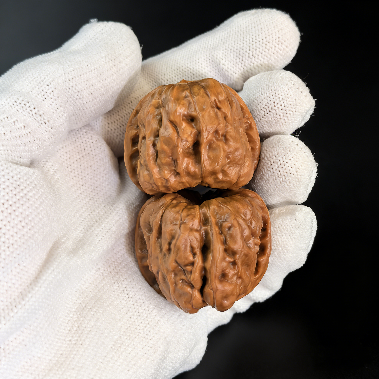 Pair of walnut hand exercisers from The Patina Project featuring Toad Head low-profile architecture, 36mm collector’s size.
