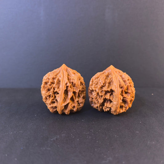 Pair of Nine Dragon Muscle walnut hand exercisers with 39mm deep ridges from ThePatinaProject, designed for grip strength training.