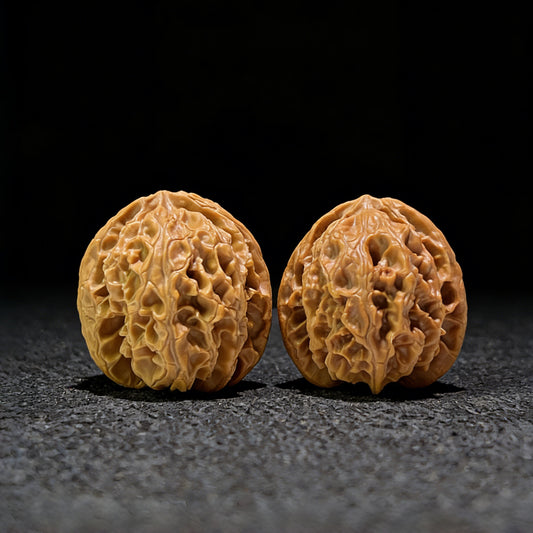 Walnut hand exerciser pair labeled "Apple Round," 32mm x 34mm, by ThePatinaProject, featuring smooth, natural wood finish.