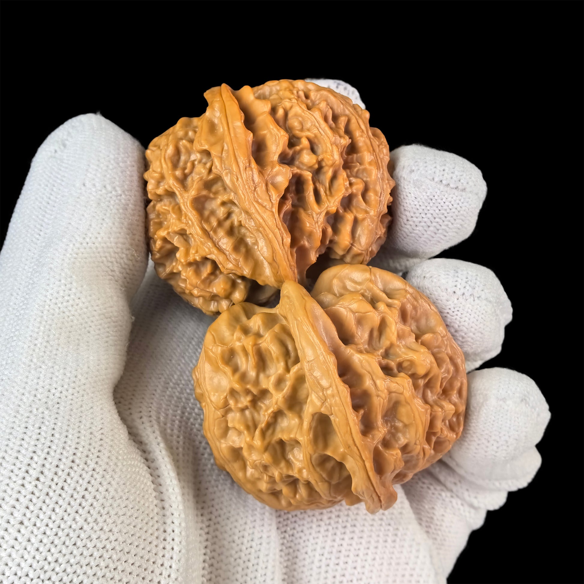 Walnut hand exerciser called the "Apple Round" by ThePatinaProject, 43mm diameter, featuring a smooth, polished walnut surface.