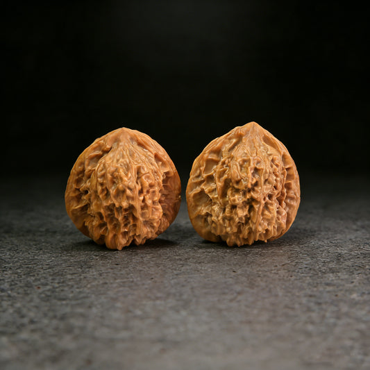 Pair of Walnut Hand Exercisers called Arhat Head, 40mm x 37mm, from ThePatinaProject, with detailed carved design.