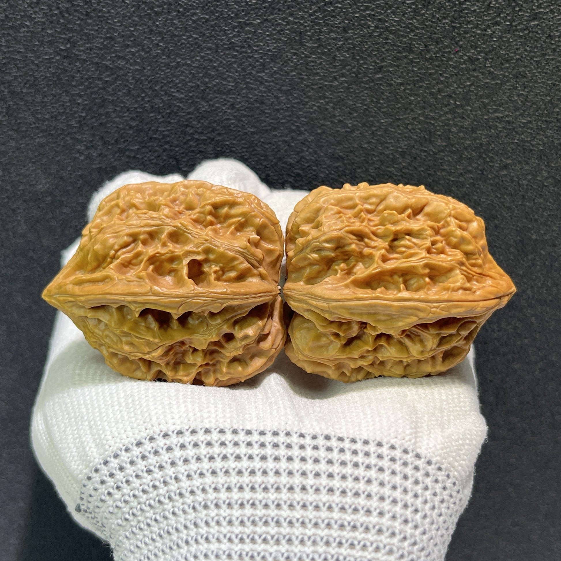 Pair of Beijing Chicken Heart walnut hand exercisers from ThePatinaProject, 38x39mm, with detailed wood grain and smooth finish.
