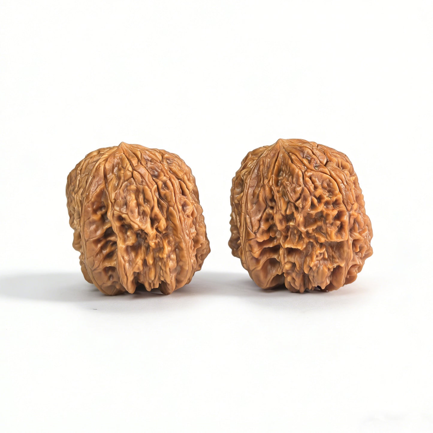 Pair of Walnut Hand Exercisers called "Blizzard" by ThePatinaProject, featuring Tian Can mutation, measuring 38x41mm.