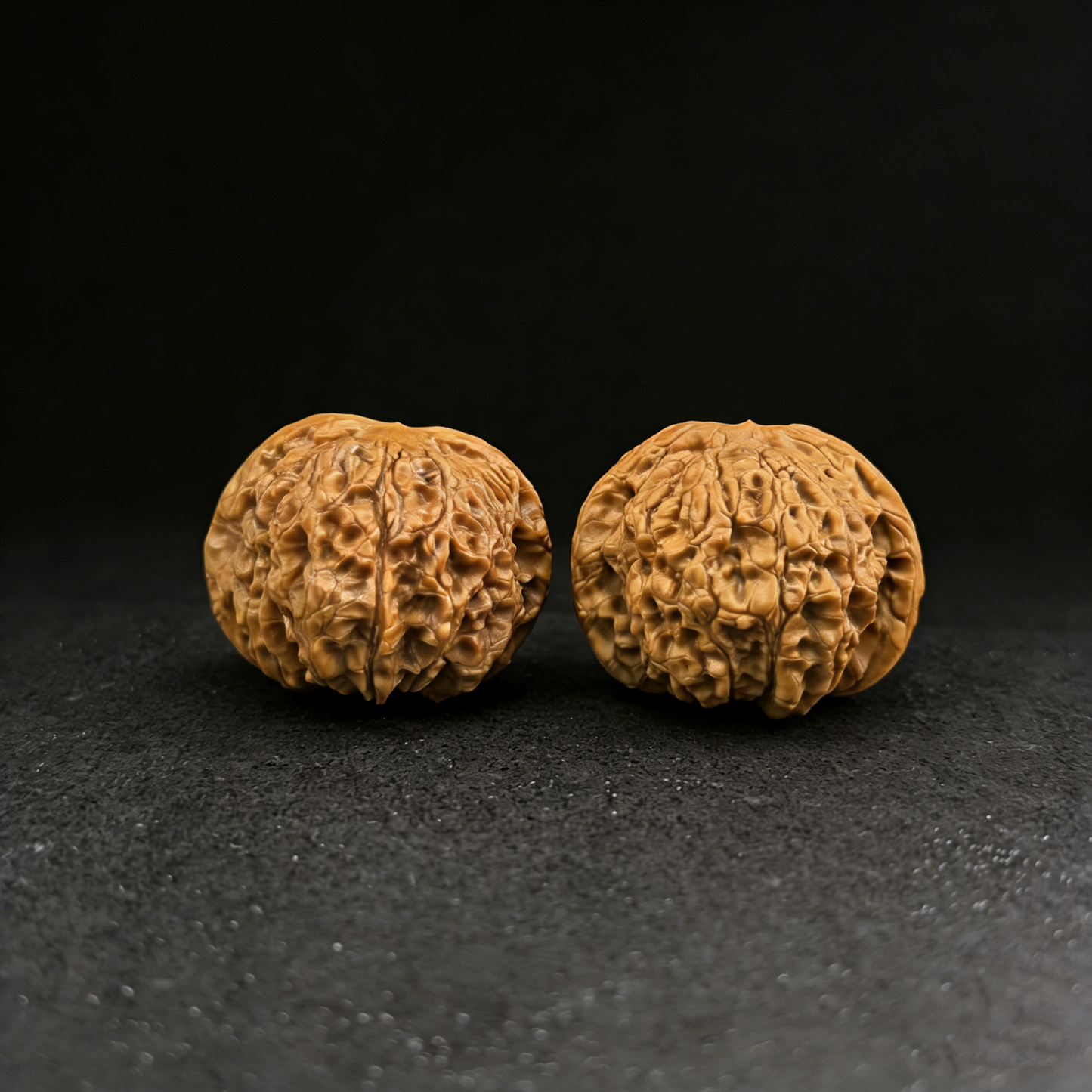 Pair of 43mm Blood Qilin Walnut Hand Exercisers with red patina finish, titled "TheBlood Qilin" by ThePatinaProject.