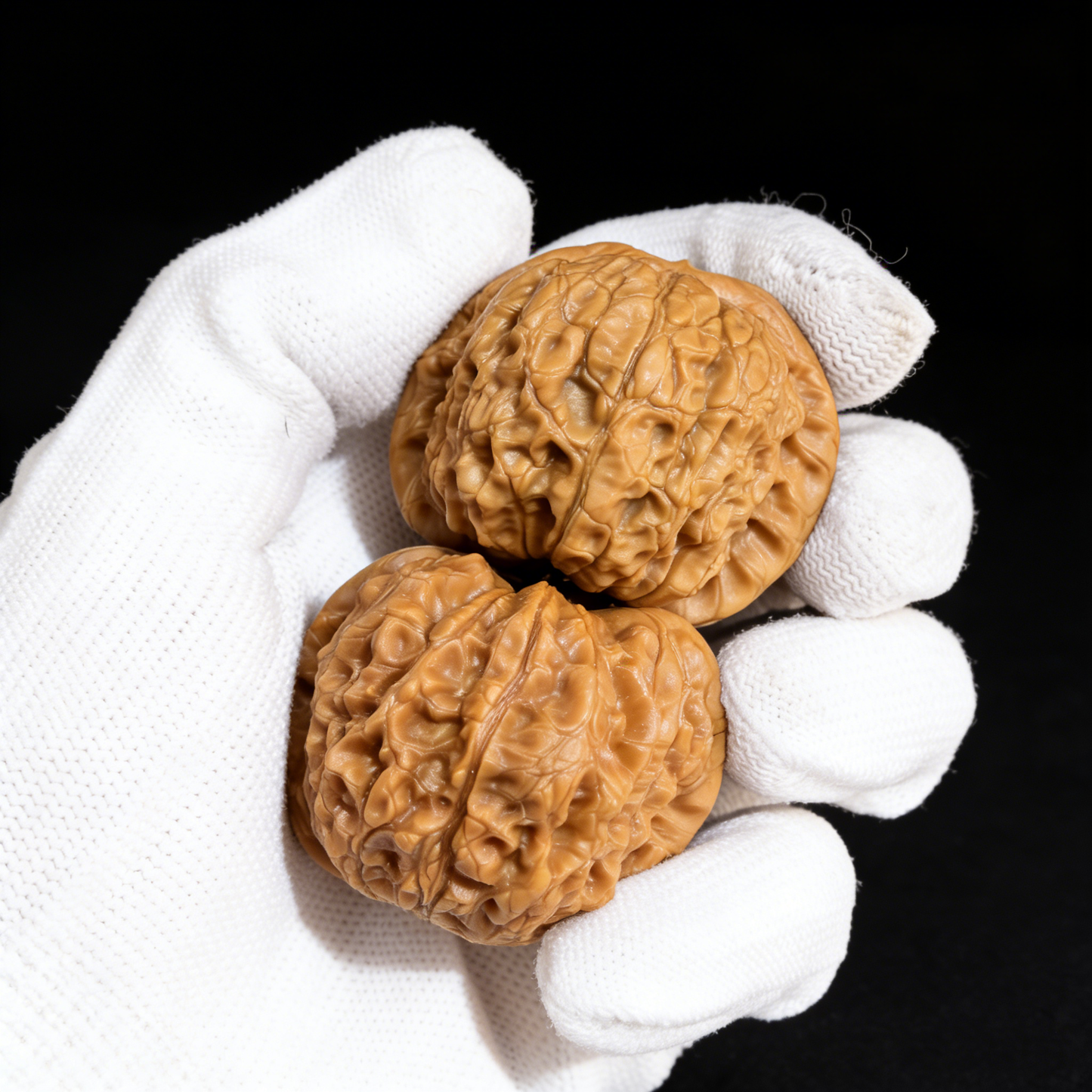 Pair of 43mm Blood Qilin Walnut Hand Exercisers by ThePatinaProject with red patina finish, showcasing detailed carved mythical creature designs.