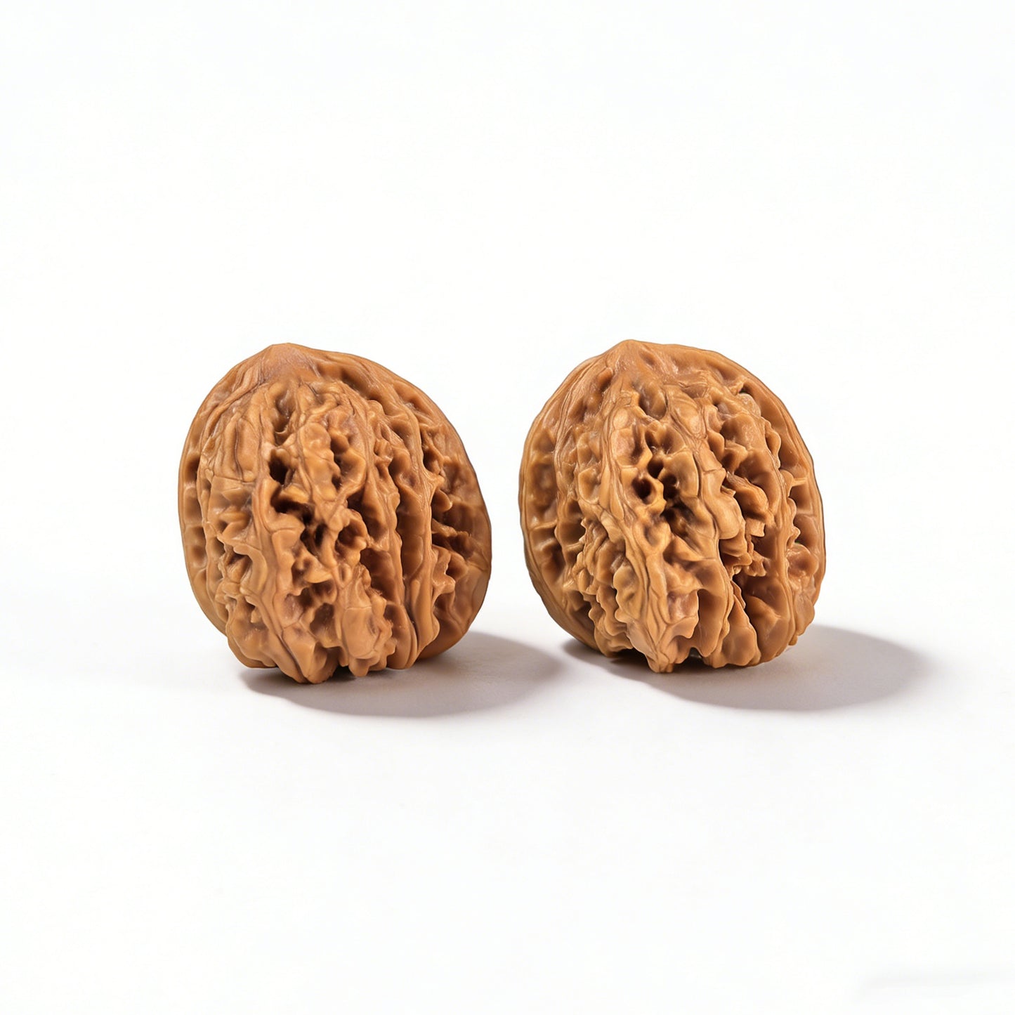 Walnut hand exerciser pair "Caterpillar" by ThePatinaProject, 34mm MMC-01, showing textured walnut grips for grip strengthening.