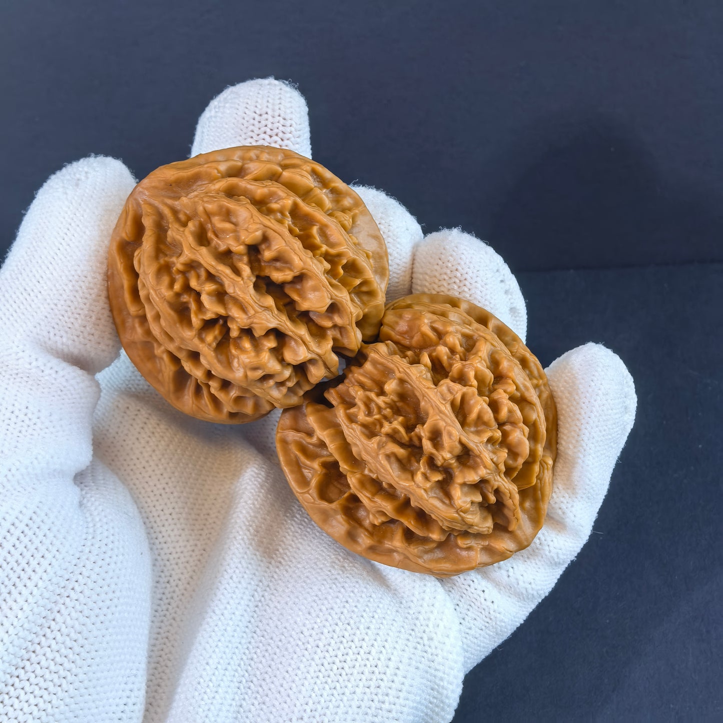 Pair of walnut hand exercisers branded ThePatinaProject with "Champion's Crown" engraving, 43mm premium collector's size.