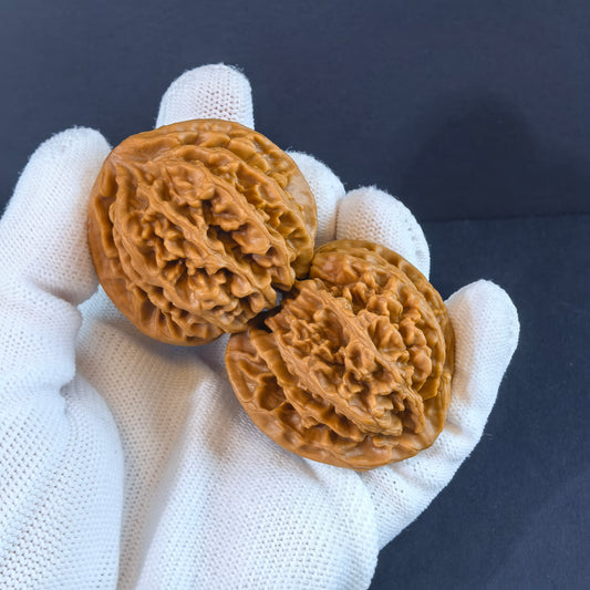 Pair of walnut hand exercisers branded ThePatinaProject with "Champion's Crown" engraving, 43mm premium collector's size.
