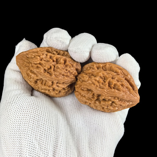 Pair of Chilong Chicken Heart Walnut Hand Exercisers by ThePatinaProject, 45mm size, featuring intricate red dragon Jixin design.