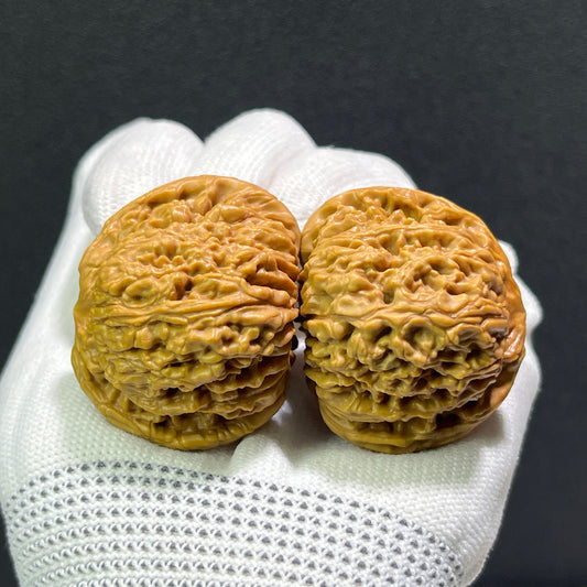 Walnut hand exercisers by ThePatinaProject, classic NJS pair, measuring 41.0mm x 43.0mm, with textured wooden surfaces.