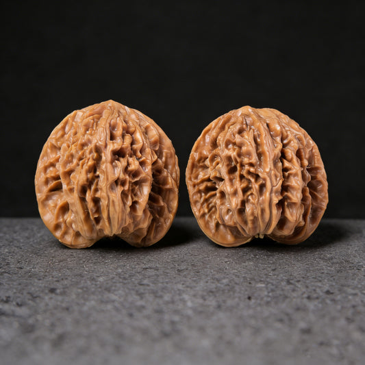 Walnut hand exerciser pair featuring coiled dragon design, 43mm x 34mm, by ThePatinaProject, showcasing intricate carved details.