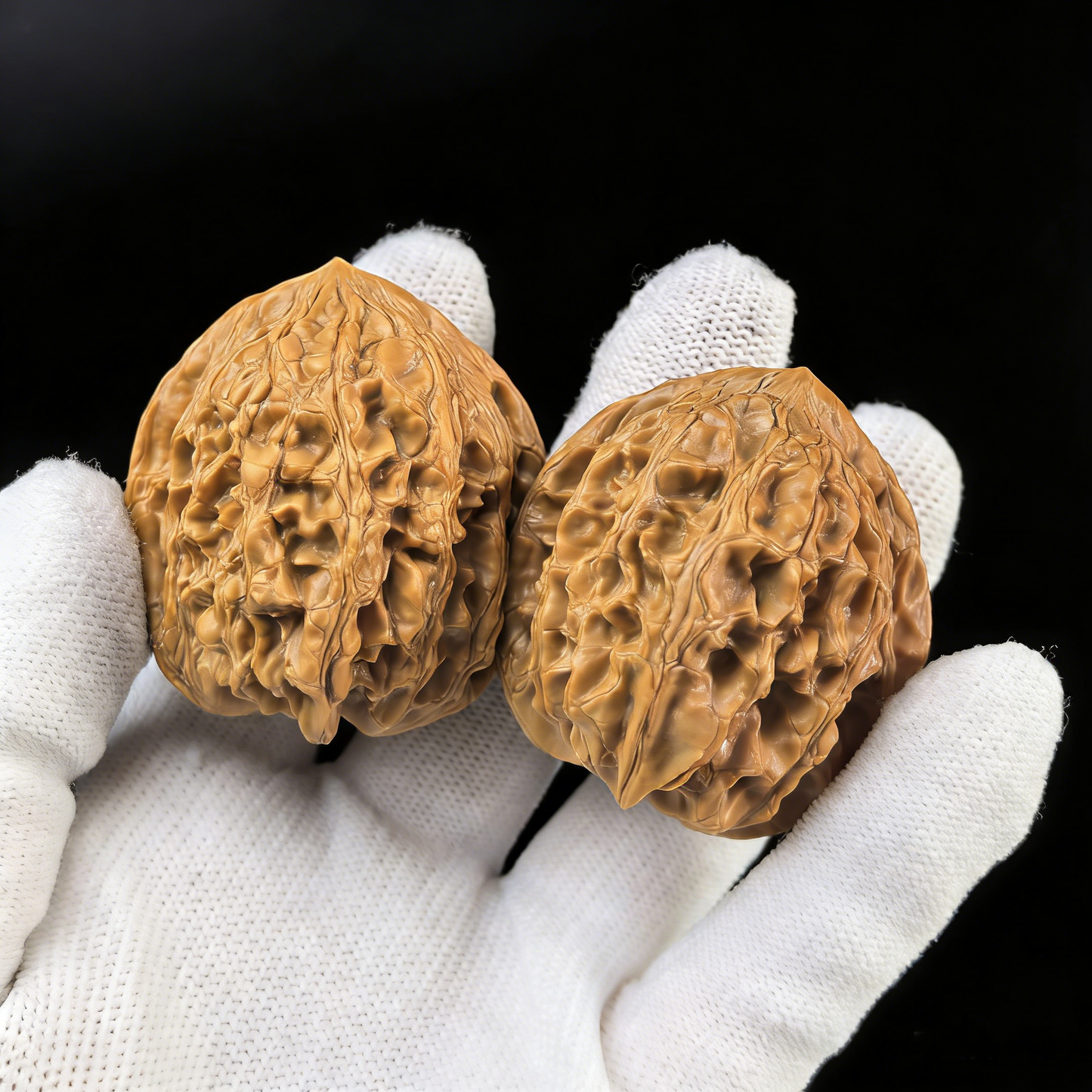 Pair of walnut hand exercisers called "Da Gu Shi" from ThePatinaProject, featuring large 41.1mm stones for grip strength training.