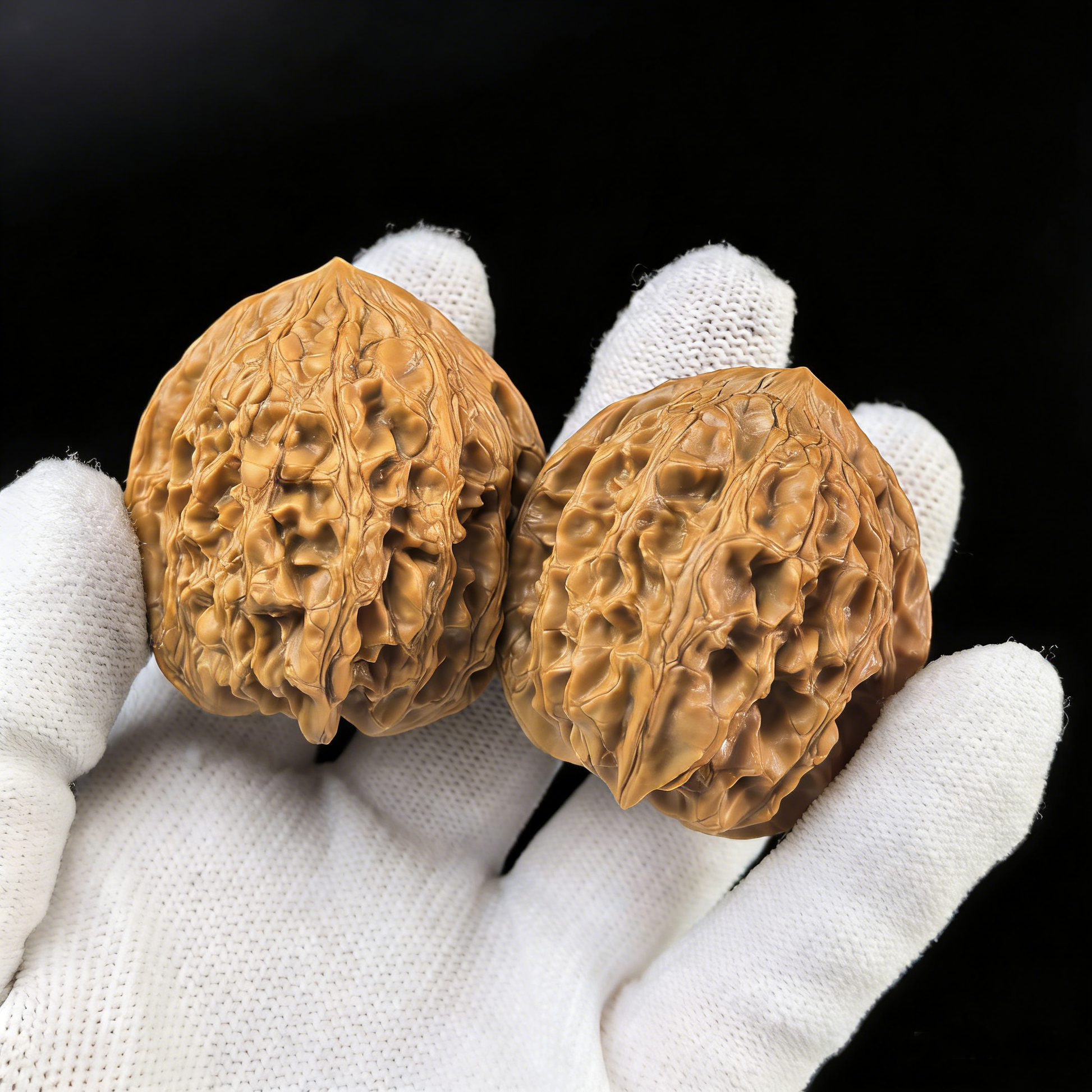 Pair of walnut hand exercisers called "Da Gu Shi" from ThePatinaProject, featuring large 41.1mm stones for grip strength training.