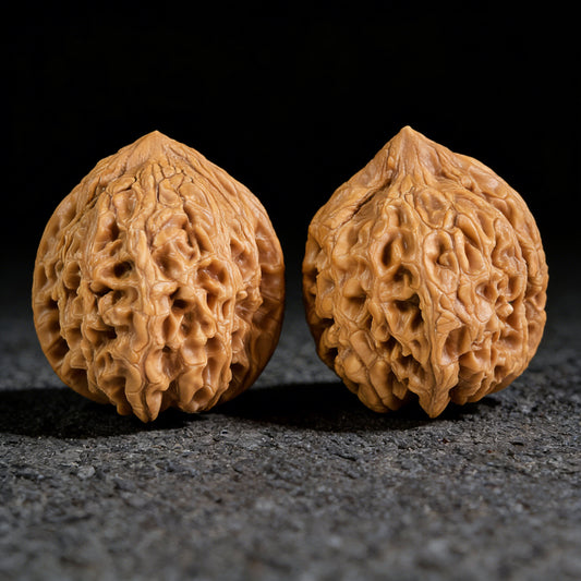 Walnut hand exercisers pair called Da Gu Stone by ThePatinaProject, 43mm x 43mm, showing textured wooden grips and natural finish.