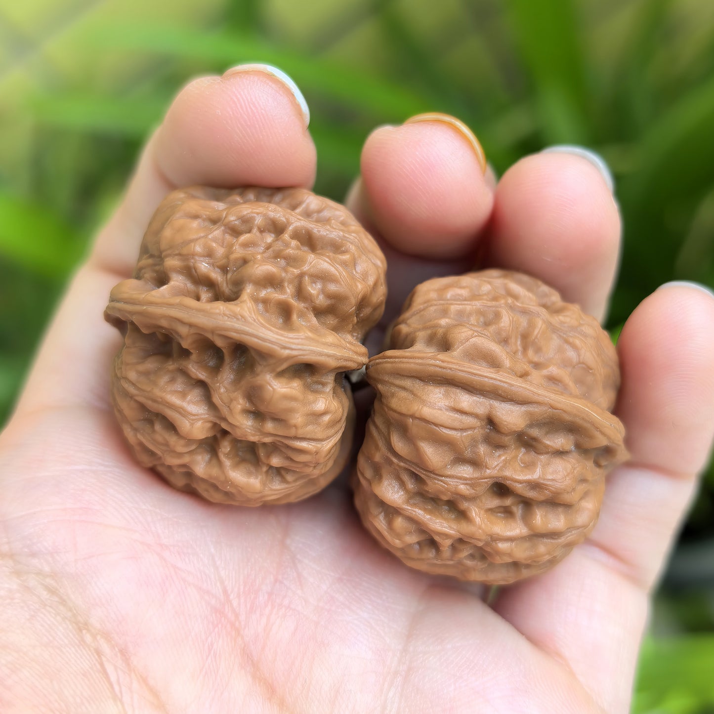 Pair of Walnut Hand Exercisers called De Tou Gou (Yuanbao) by ThePatinaProject, measuring 32mm x 31mm, shown in the image.