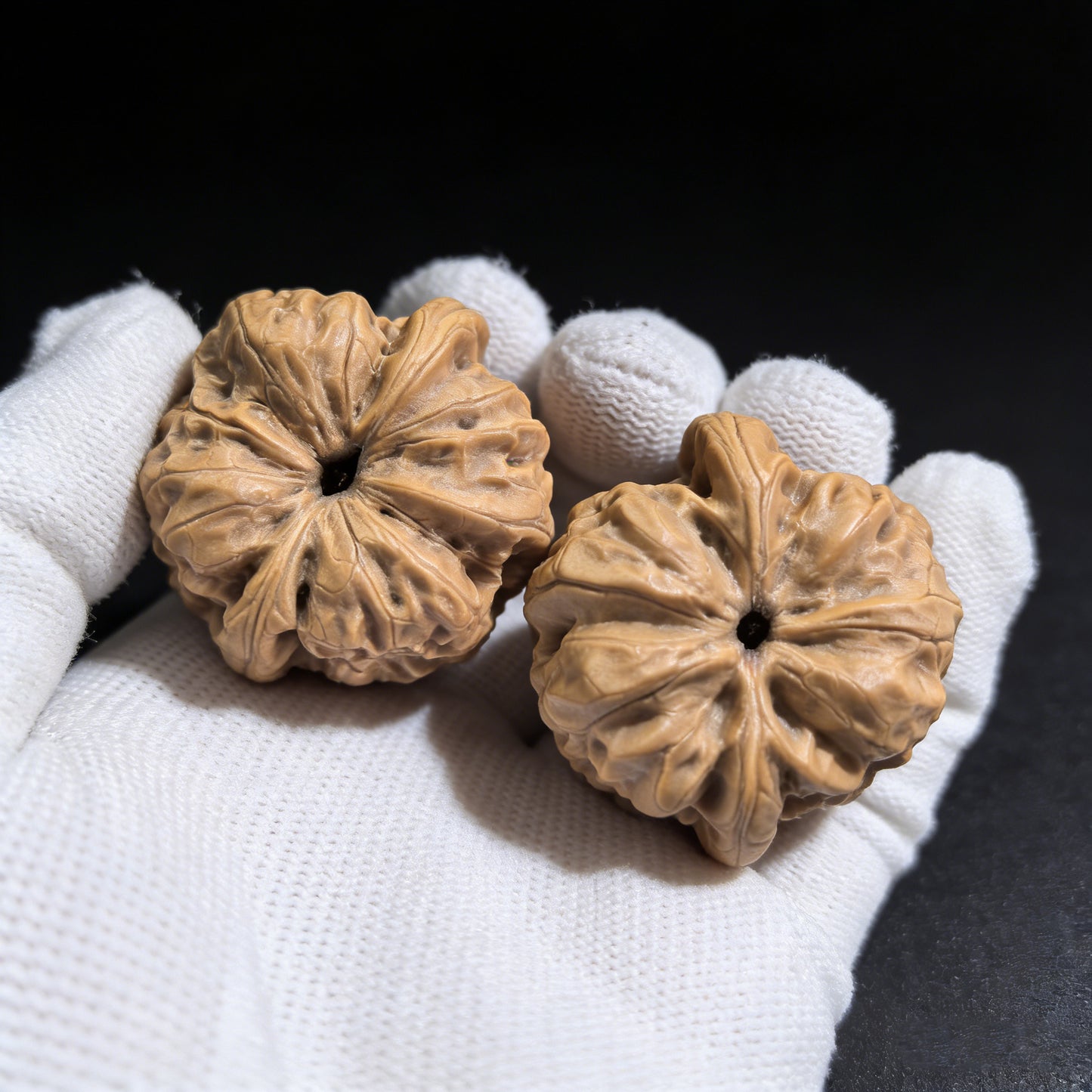 Walnut hand exercisers pair titled "Dharma" by ThePatinaProject, measuring 35mm x 34mm, showing textured walnut surface and design details.