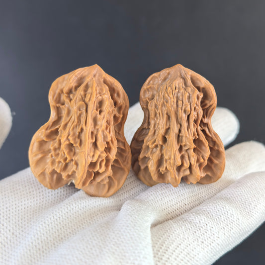 Pair of Walnut Hand Exercisers "Double Gourd" Hulu by ThePatinaProject, 29mm, showing textured walnut surface and ergonomic shape.