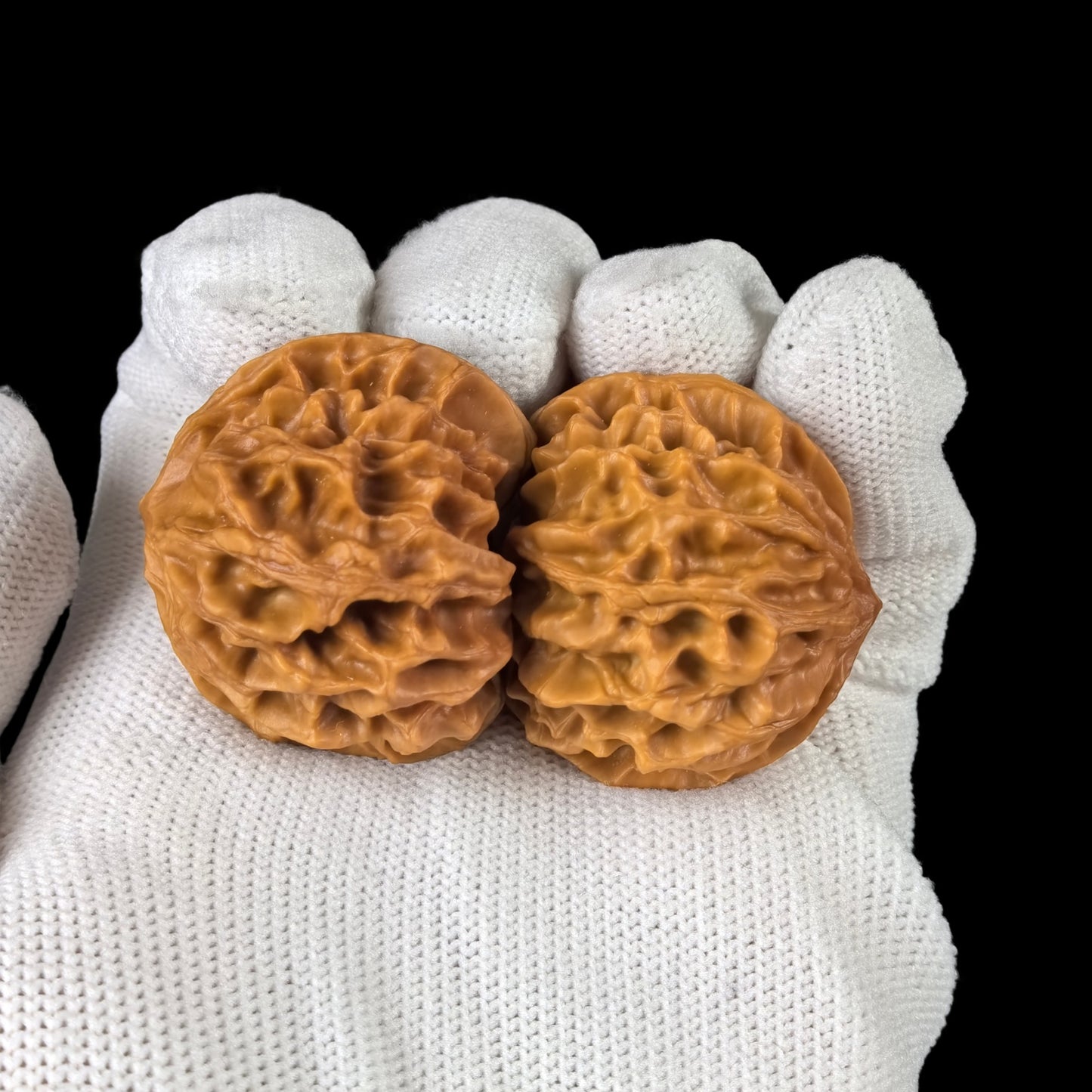 Walnut hand exercisers, the "Dragon Pearl" pair by ThePatinaProject, 33mm size, showing textured walnut surface and ergonomic design.