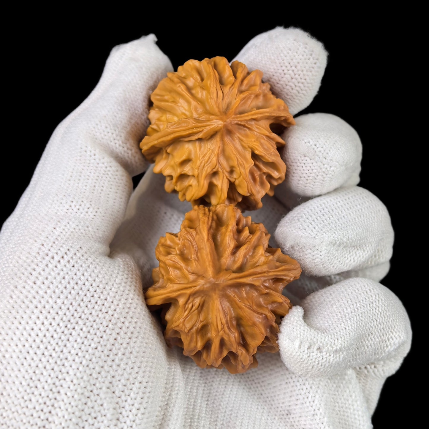 Walnut hand exerciser pair called Dragon Pearl, 33mm size, from ThePatinaProject, shown with textured walnut surfaces.