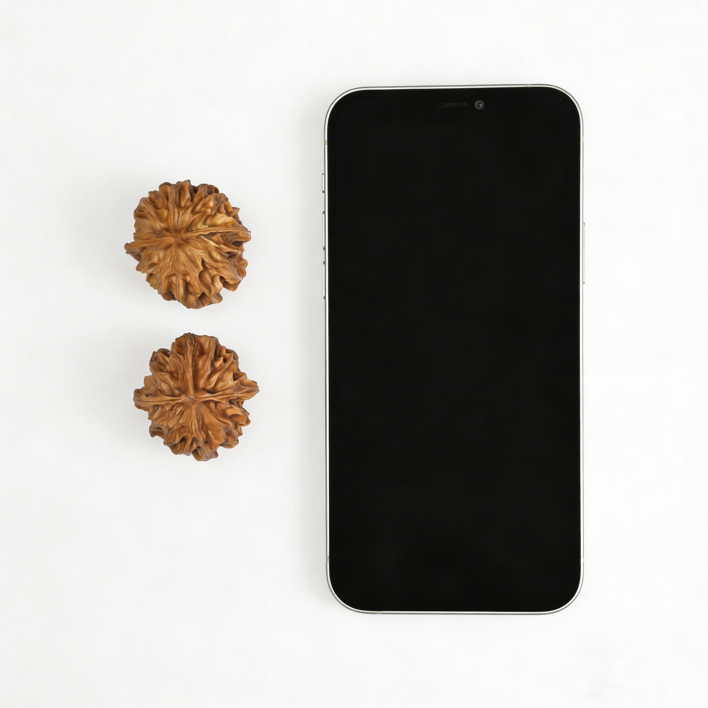 Walnut hand exercisers pair, Dragon Pearl XLZ-01 model, 33mm, by ThePatinaProject, showing textured walnut surface for grip and exercise.