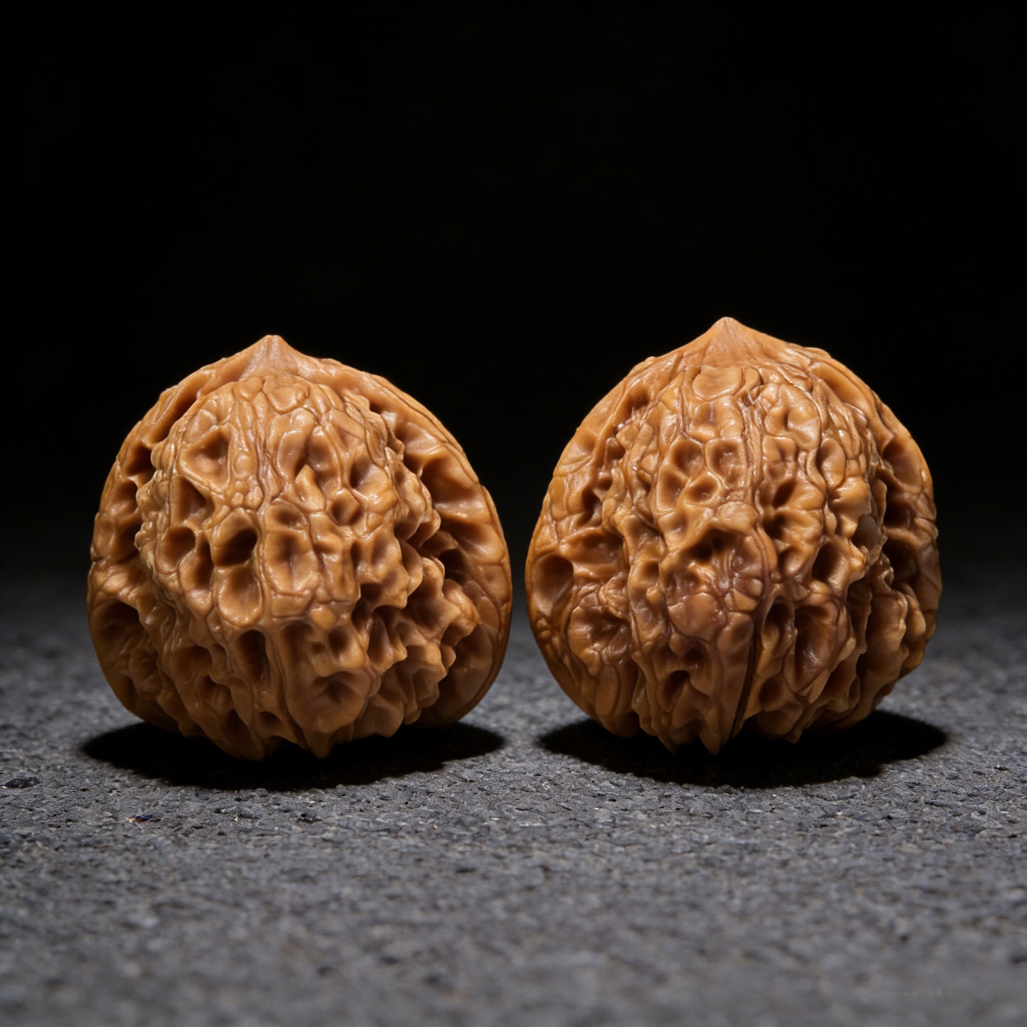 Pair of Walnut Hand Exercisers with 34mm diameter from ThePatinaProject, showcasing smooth, rounded wooden grips for hand strength training.