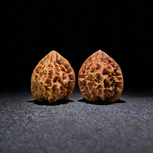 Walnut hand exerciser pair "Emperor" DW-602 by ThePatinaProject, 45mm x 45mm, showing textured walnut surface and ergonomic design.