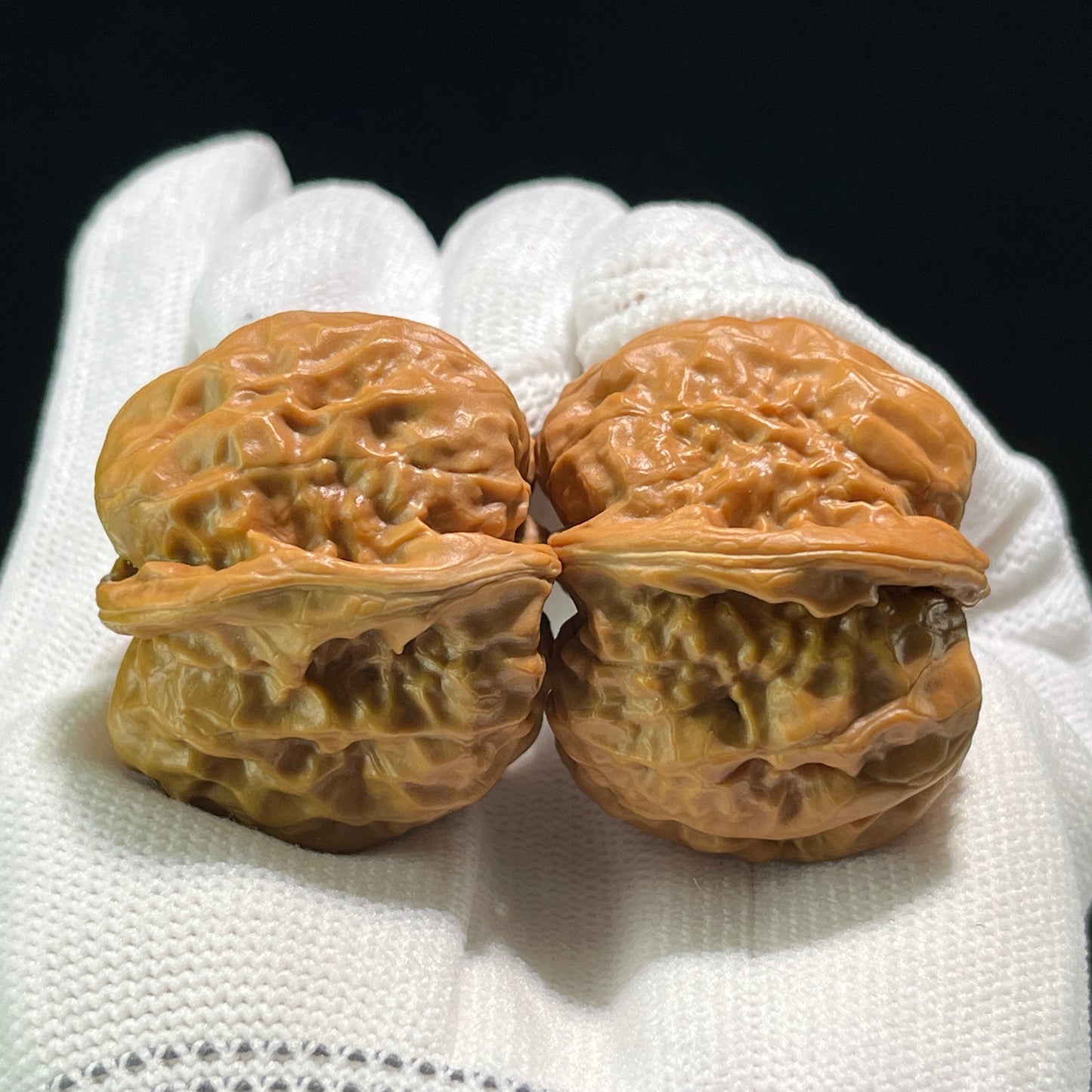 Walnut hand exercisers called "Frog" pair by ThePatinaProject, W-601, with 36mm and 38mm size, shown in natural wood finish.