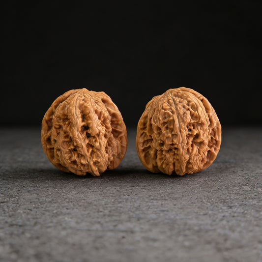 Walnut hand exercisers called "The General's Shoulders" by ThePatinaProject, 39mm x 38mm, showing textured walnut surface.