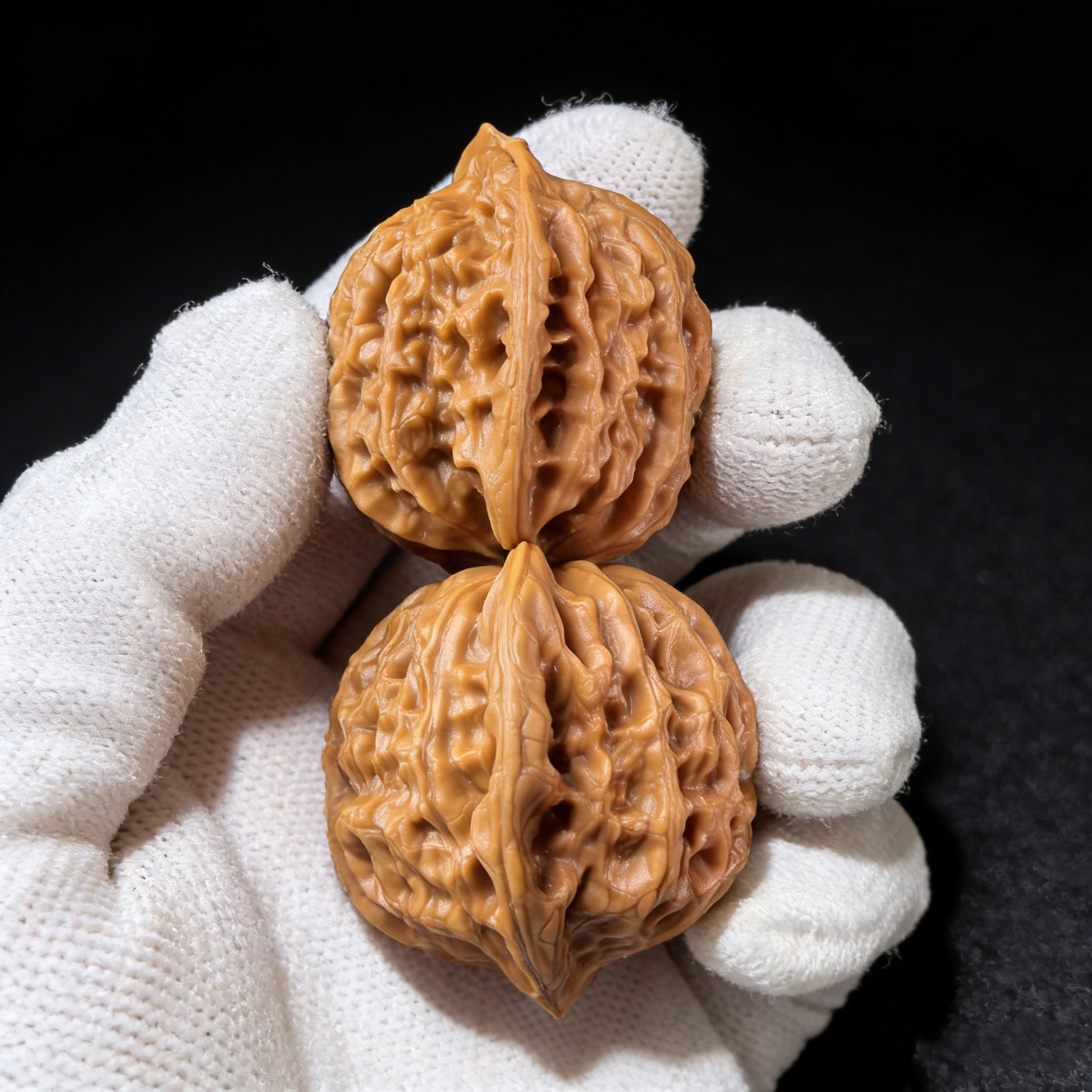 Pair of Walnut Hand Exercisers labeled GZM-02 by ThePatinaProject, showing smooth wooden surface and ergonomic shape for grip and strength.