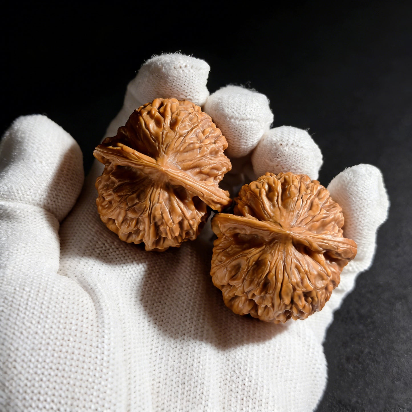 Walnut hand exercisers called Golden Ingot pair by ThePatinaProject, 47mm, featuring intricate design and polished finish.