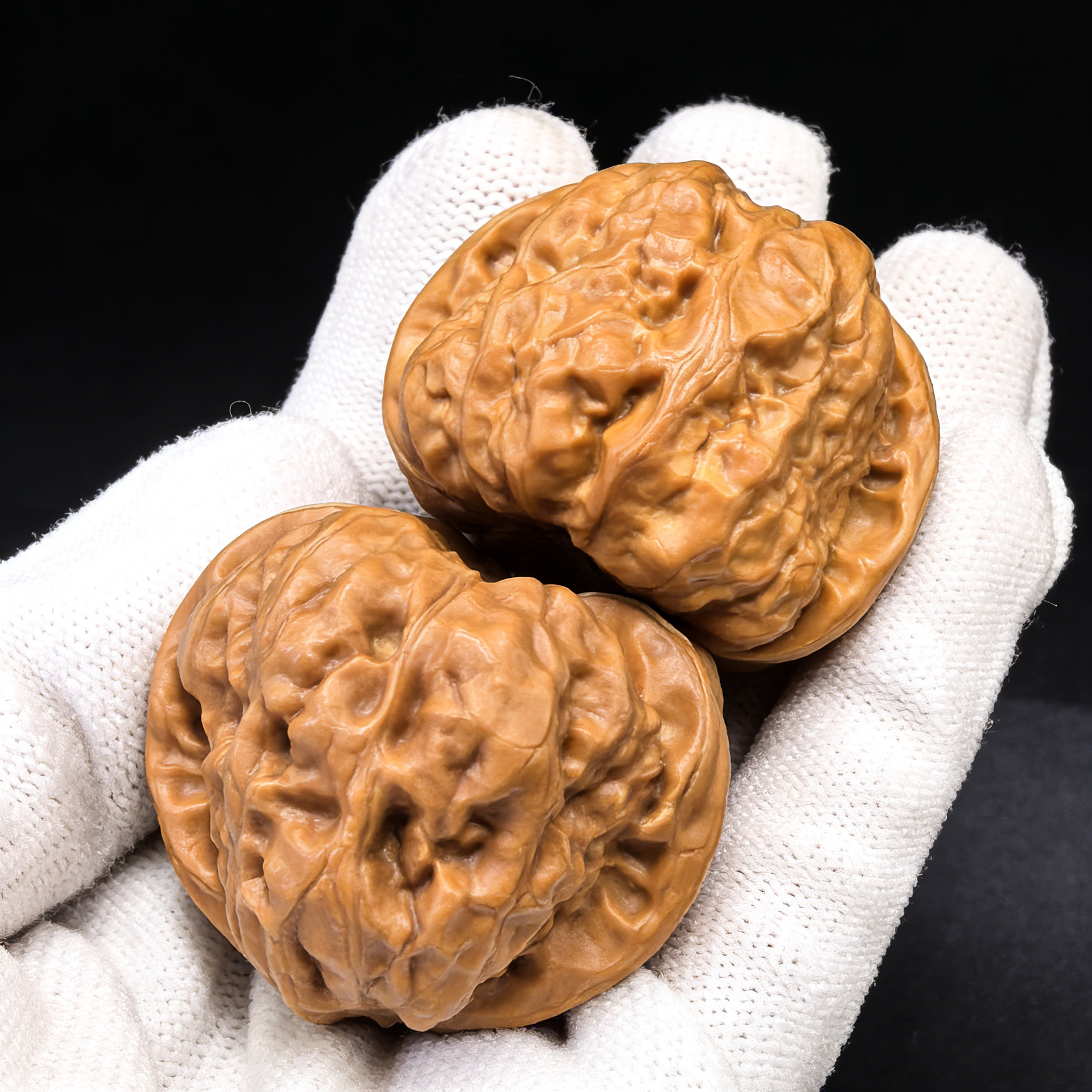 Walnut hand exercisers featuring the Golden Money Toad design, shown as a pair of 40mm rare pictographic Walnut hand grips.