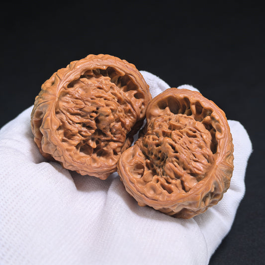 Walnut hand exercisers featuring Golden Mountain Treasure Bowl snake head pair from ThePatinaProject, collection grade, 46mm x 37mm.