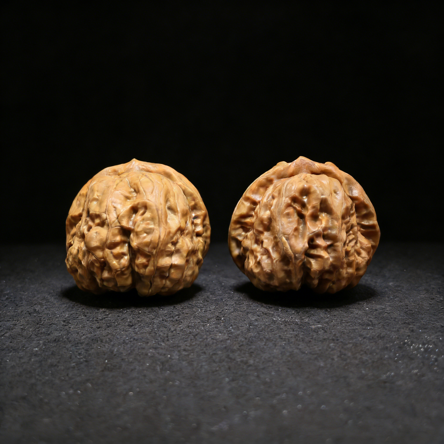 Walnut hand exerciser pair called Golden Toad (Ha Ma Tou) by ThePatinaProject, 39mm wealth guardian shown in the image.